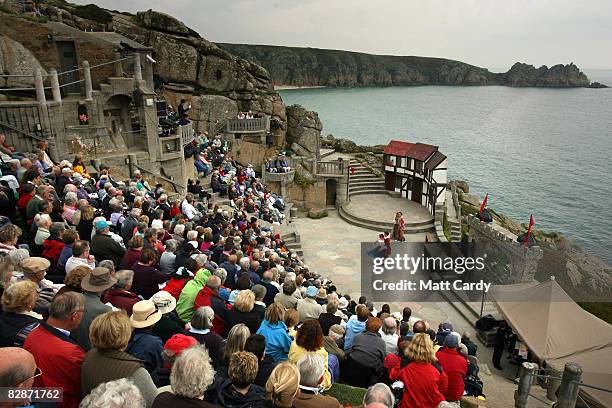 People watch as members of Cambridge University's Gilbert and Sullivan Society perform 'The Yeomen Of The Guard' at the Minack Theatre's penultimate...
