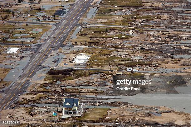 Home is left standing among debris from Hurricane Ike September 14, 2008 in Gilchrist, Texas. Floodwaters from Hurricane Ike are reportedly as high...