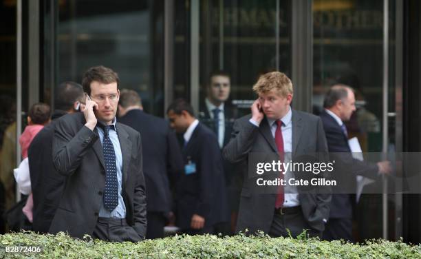 Workers outside Lehman Brothers' Canary Wharf office on September 15, 2008 in London, England. The fourth largest American investment bank has...