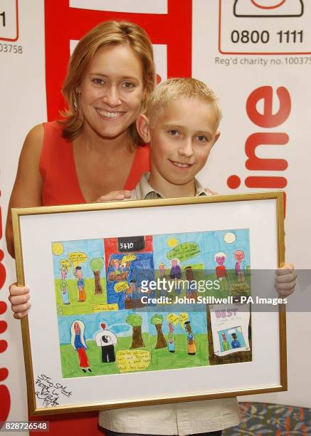 Peter Reid from Buckie, Moray, with BBC TV news presenter Sophie Raworth, and his award winning cartoon which he entered in the Childline Cartoon...