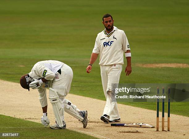 Shoaib Akhtar of Surrey kneels on the wicket after being hit by a delivery from Andre Adams of Nottinghamshire during the second day of the LV County...