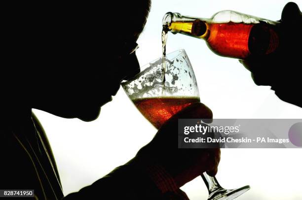 Alastair Mowat, a director of Edinburgh brewers Innis & Gunn's, samples, some of its newly-unveiled oak-aged beer, which is matured in the same style...