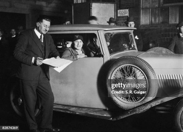 British racing driver Joan Chetwynd checking out at the Piccadilly Garage, London, on her way to compete in the Monte Carlo Rally in her Lea Francis...