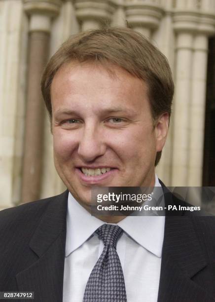 Steve Horkulak, a former employee of money brokers Cantor Fitzgerald, smiles for the press outside the Royal Courts of Justice in central London,...
