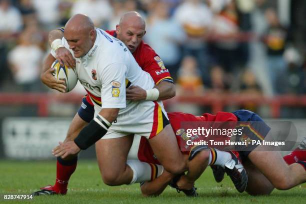 London Broncos Steele Retchless and Russell Bawden tackle Bradford Bull's Paul Anderson during tonight's Tetley's Super League VIII Round 7 match at...