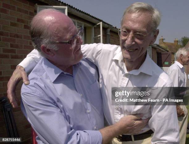 Great Train Robber Bruce Reynolds meets former police officer John Woolley at Oakley Village Hall, Buckinghamshire, during a village fete. Mr Woolley...