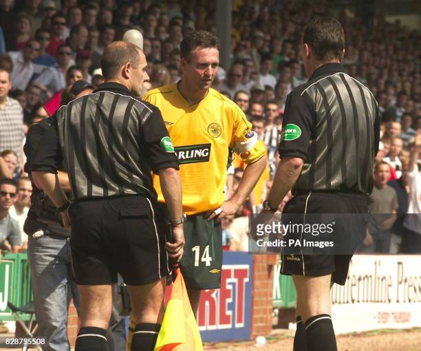 Celtic's captain Paul Lambert chats to the linesman and referee Hugh Dallas after team-mate Henrik Larsson is hit by ball thrown from crowd during...