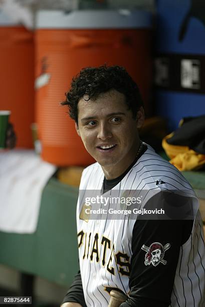 Shortstop Luis Cruz of the Pittsburgh Pirates smiles while sitting in the dugout during a game against the St. Louis Cardinals at PNC Park on...