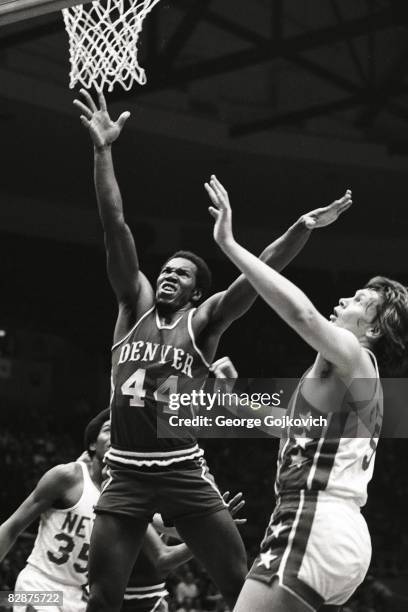Ralph Simpson of the Denver Rockets/Denver Nuggets goes up for a rebound against Billy Paultz of the New York Nets during an American Basketball...
