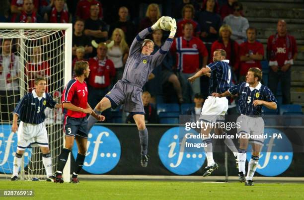 Scotland keeper Robert Douglas saves successfully an attack on goal with Christian Dailly, Andy Webster and Gary Naysmith and Norway's Claus...