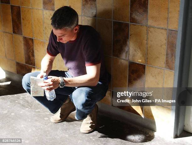 Great Britain athlete Jonathan Edwards waits for a train after announcing his decision to retire from competition at a press conference in Paris,...