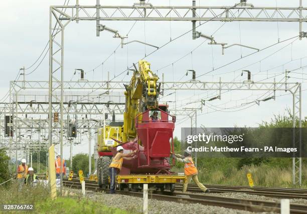 Workmen attend to parts of the west coast main line track near Leighton Buzzard, Bedfordshire. Network Rail are carrying out track work on the August...