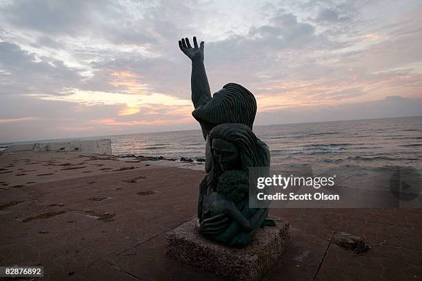 As the island continues to recover from Hurricane Ike, the sun rises behind the 1900 Storm Memorial September 18, 2008 in Galveston, Texas. The...