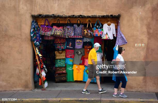 Tourists walk past a clothing and souvenir shop in Santa Fe, New Mexico.