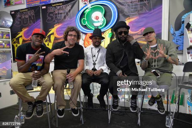 Damien Scott and Benjamin Jackendoff and musicians apl.de.ap, will.i.am and Taboo of The Black Eyed Peas pose at an in-store signing and livestream...