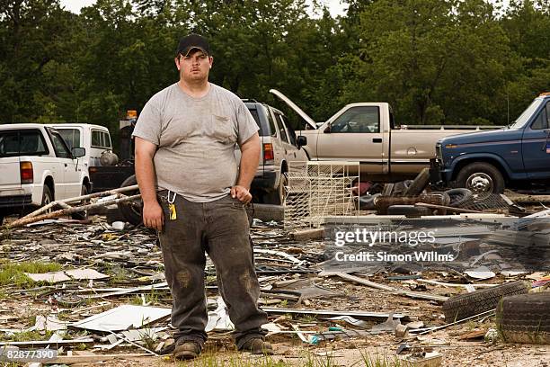 man standing in front of wrecking yard - autoschrottplatz stock-fotos und bilder