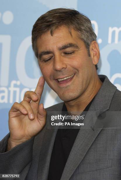 Actor George Clooney poses for photographers to promote his new film 'Intolerable Cruelty' during the Venice Film Festival at Mostra Internazionale...
