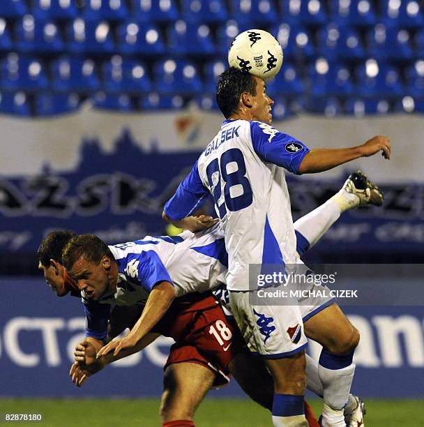 Alexandr Prudnikov of Spartak Moscow fights for a ball with Daniel Tchur and Tomas Galasek both of Banik Ostrava during their first leg of first...