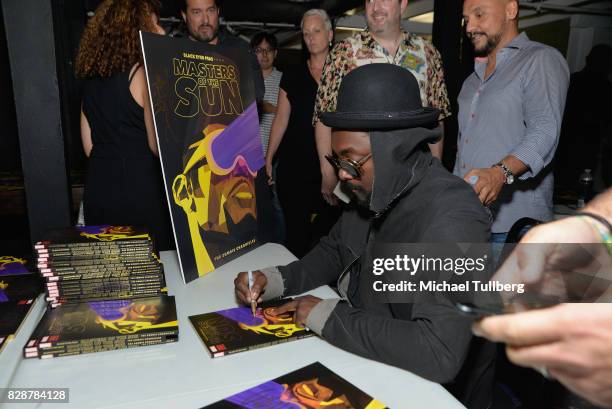 Will.i.am of The Black Eyed Peas signs merchandise at an in-store signing and livestream for the graphic novel "Masters of the Sun" at Meltdown...