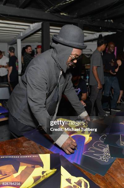 Will.i.am of The Black Eyed Peas signs merchandise at an in-store signing and livestream for the graphic novel "Masters of the Sun" at Meltdown...