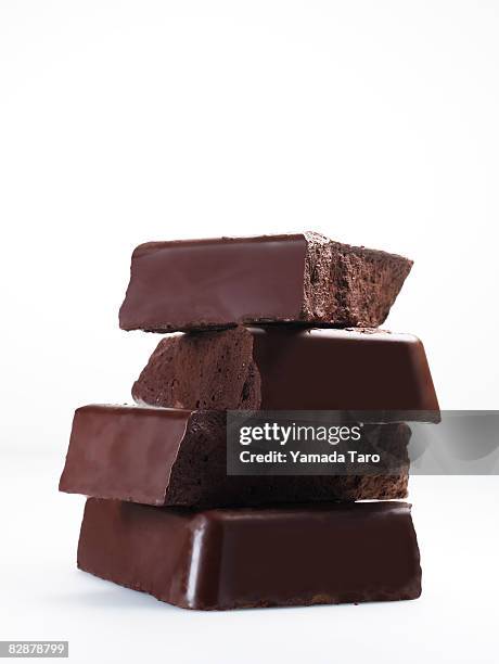 stacked chocolate chunks - chocolate bar stock pictures, royalty-free photos & images