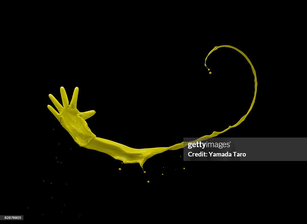 Yellow latex glove in the air