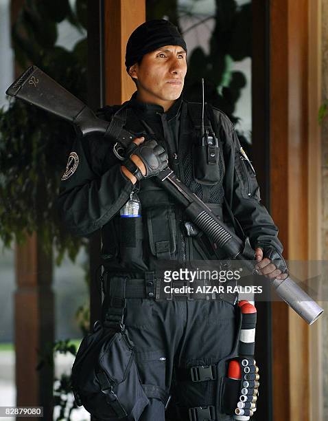 An anti-riot policeman guards the place where a meeting between Bolivian President Evo Morales and opposition governors takes place on September 18...