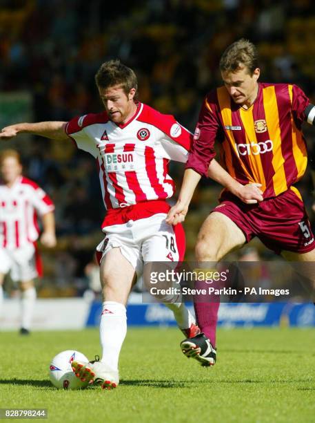 Sheffield United's Michael Tonge and Bradford City's David Wetherall battle for the ball during their Nationwide Division One match at Valley Parade,...