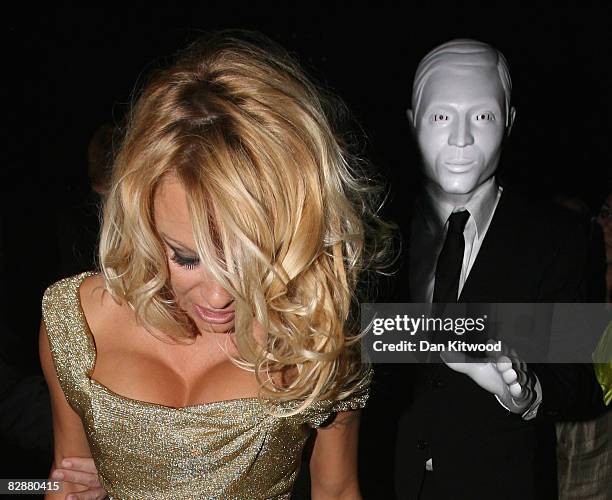 Pamela Anderson and a mystery man attends the Vivienne Westwood Spring/Summer 2009 collection catwalk during London Fashion week on September 18,...