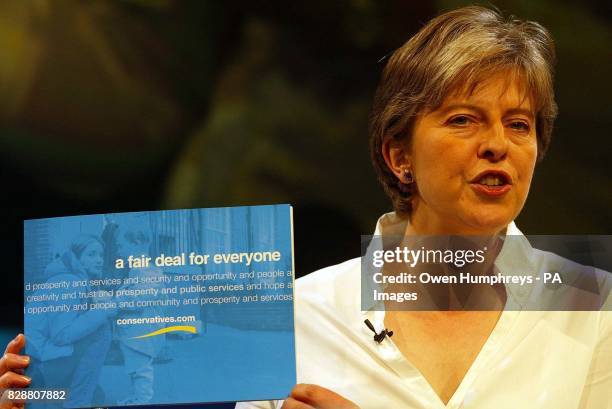 Conservative Party Chairman Theresa May unveils her party's latest policy document, a fair deal for everyone, at the conference hall in the Winter...