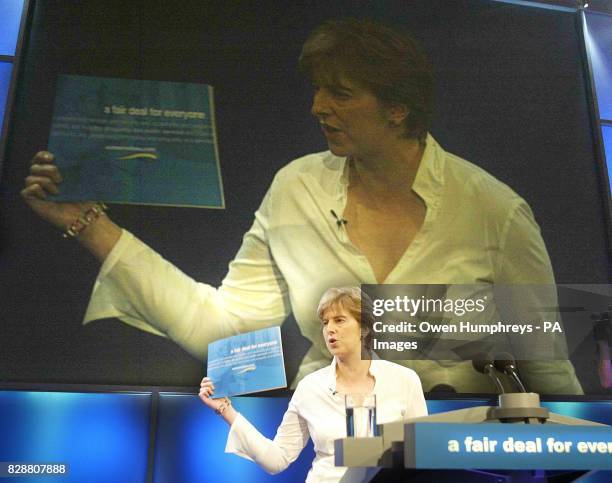 Conservative Party Chairman Theresa May unveils her party's latest policy document, a fair deal for everyone, at the conference hall in the Winter...