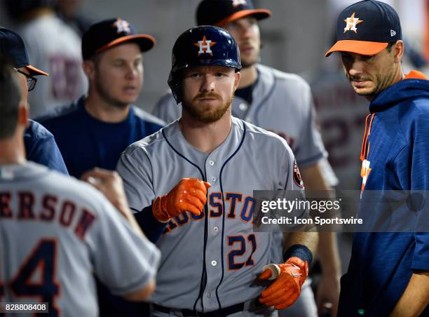 Houston Astros left fielder Derek Fisher celebrates in the dugout after hitting a solo home run during the game between the Houston Astros and the...