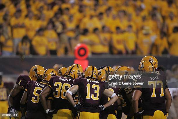 Arizona State Sun Devils players huddle with their student fan section behind them during a game against the UNLV Rebels at Sun Devil Stadium in...
