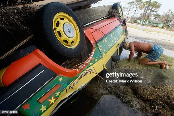 Al Newman looks at the damage of his car that was parked where he rode out Hurricane Ike at the Crenshaw Middle School where he has been staying...