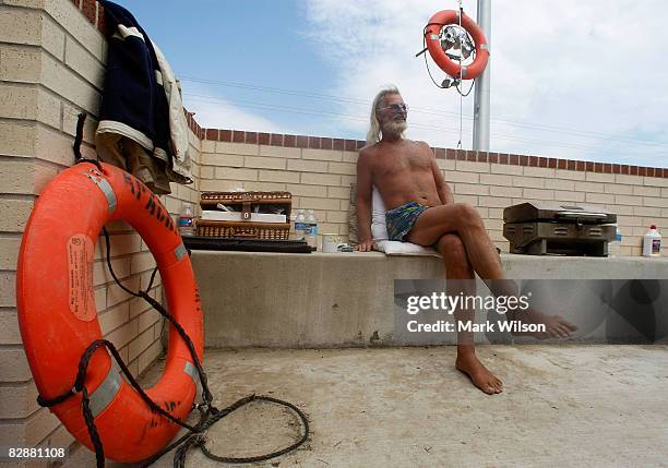 Al Newman relaxes on the front steps of the Crenshaw Middle School where he has been staying since Hurricane Ike came ashore last Saturday, on...