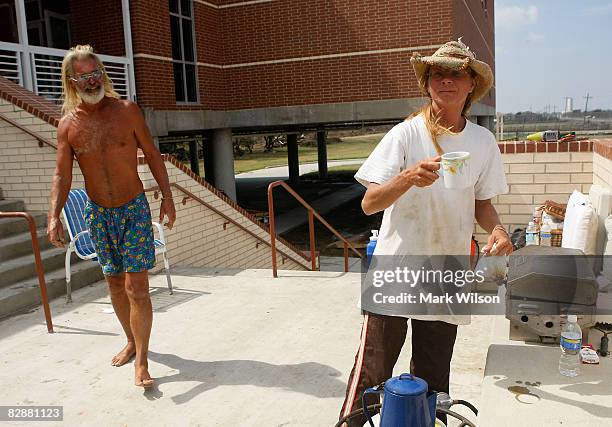 Al Newman and his girlfriend Mary Shirei feel at home on the front steps of the Crenshaw Middle School where they have been staying since Hurricane...