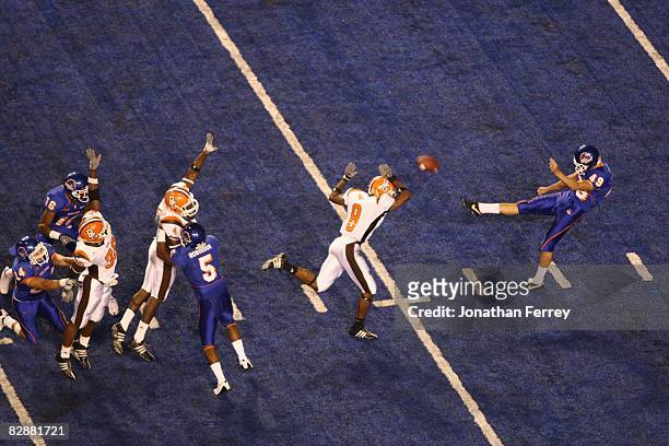 Brad Elkin of the Boise State Broncos punts the ball as Tyrone Pronty of the Bowling Green Falcons attempts to block it at Bronco Stadium on...