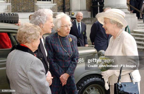 Britain's Queen Elizabeth II talks to Betty Royle from London, Pat Blake from Surrey and Patsie Young from Dorset, at the Imperial War Museum. The...