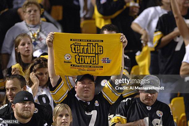 Pittsburgh Steelers fan hoists the terrible towel during play against the Miami Dolphins during the NFL's 2006 opening game on September 7, 2006 at...