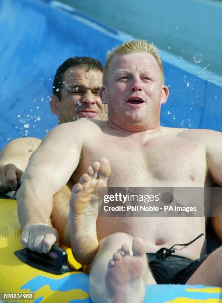 England rugby players Martin Johnson and Dorian West slide down a water chute during a team trip to the 'Wet and Wild' water park near Brisbane's...