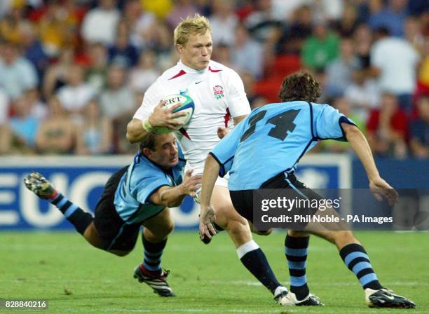 England's Josh Lewsey runs through Uruguay's Joaquin de Freitas and Joaquin Pastore during the Rugby World Cup Pool C match between England and...