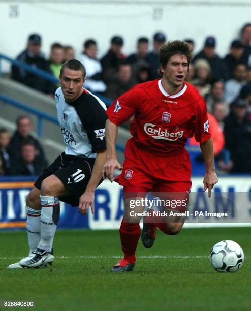 Liverpool midfielder Harry Kewell beats Fulham's Lee Clark during their FA Barclaycard Premiership match at Fulham's Loftus Road ground in London.