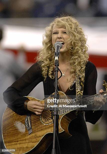 Taylor Swift sings the National Anthem as the Detroit Lions host the Miami Dolphins in a Thanksgiving Day game at Ford Field in Detroit, Michigan on...