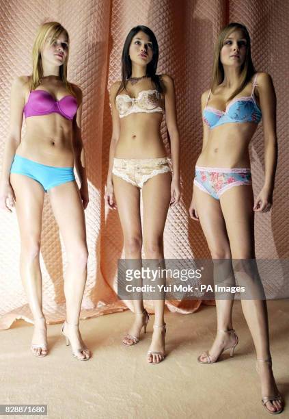 Models, from left to right; Catherine Dal, Jamie Gunns and Dominyka Gajauskaite pose for photographers during a photocall to launch the first ever...