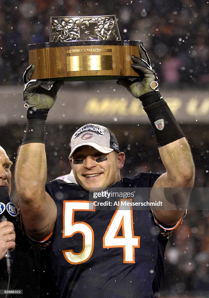 Chicago Bears linebacker Brian Urlacher holds the George Halas