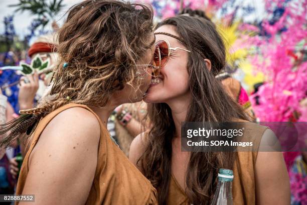 Two female participants seen kissing each other during the parade. Amsterdam Pride Parade 2017 hosted in the canals of the Dutch capital city.