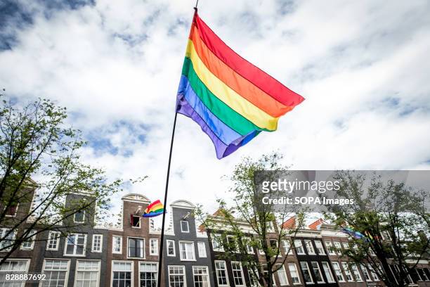 Rainbow flag being displayed along the parade route. Amsterdam Pride Parade 2017 hosted in the canals of the Dutch capital city.