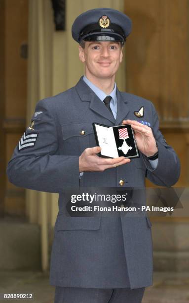 Flight Sergeant John Carrigan, from 202 Squadron RAF Lossiemouth, after being invested with an Air Force Cross from the Prince of Wales at Buckingham...