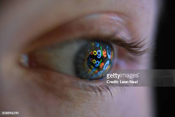 In this photo illustration, an image of the Google logo is reflected on the eye of a young man on August 09, 2017 in London, England. Founded in 1995...
