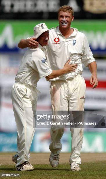 Gareth Batty congratulates Andrew Flintoff after he took the wicket of Hashan Tillakaratne to bring the only success of the morning session as...